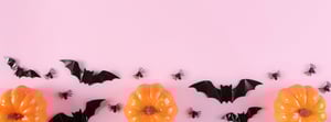 happy-halloween-holiday-with-trick-treat-pumpkins-candy-spiders-pastel-pink-background